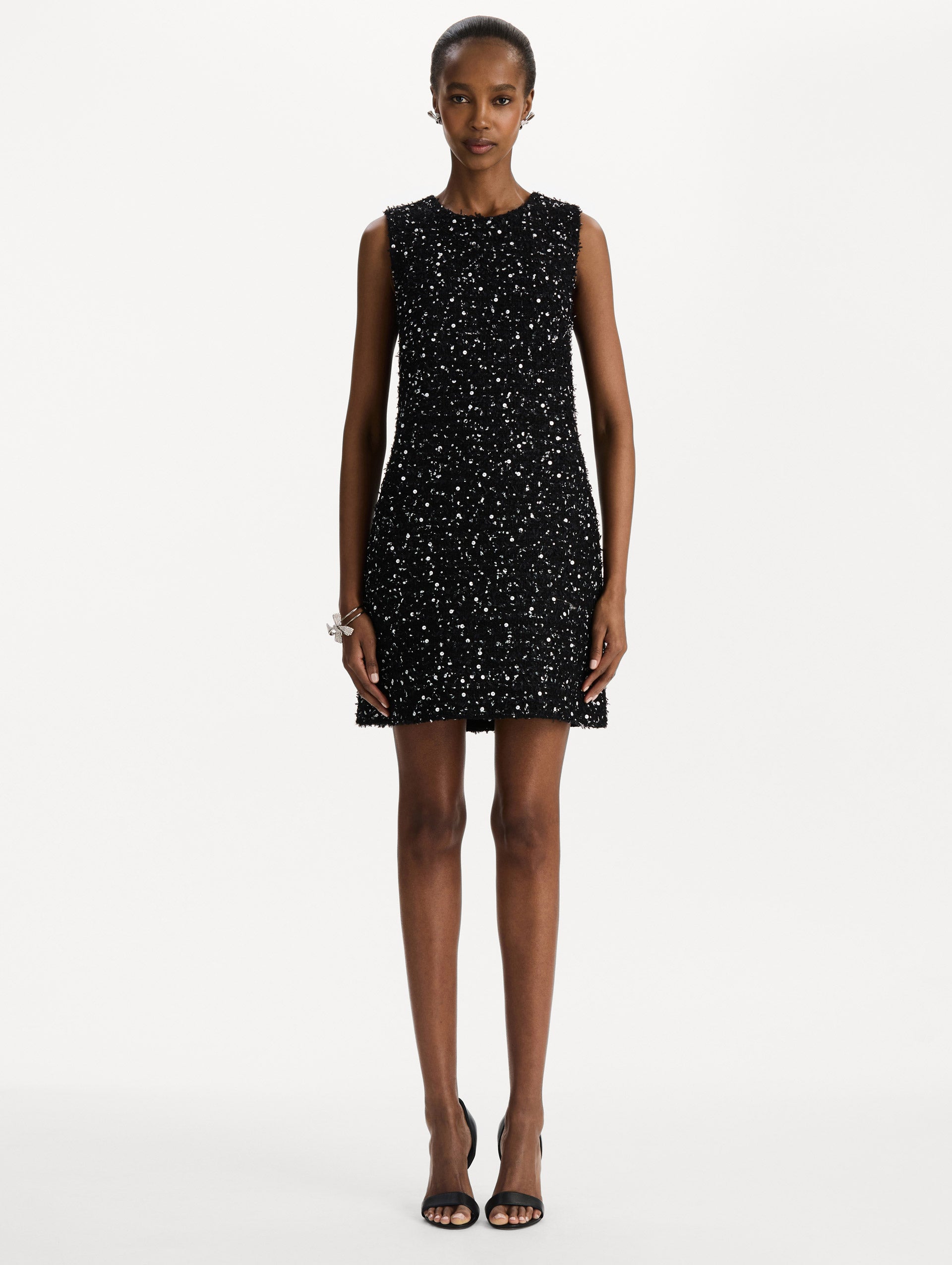The model is wearing the sequin ribbon tweed sleeveless day dress in black and white. Front view. 