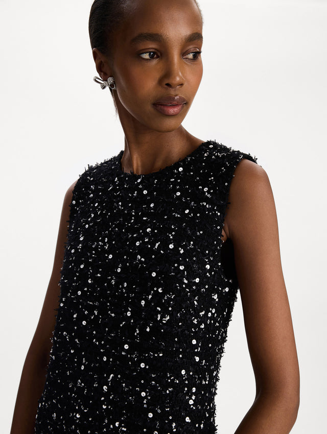The model is wearing the sequin ribbon tweed sleeveless day dress in black and white. Zoom view. 