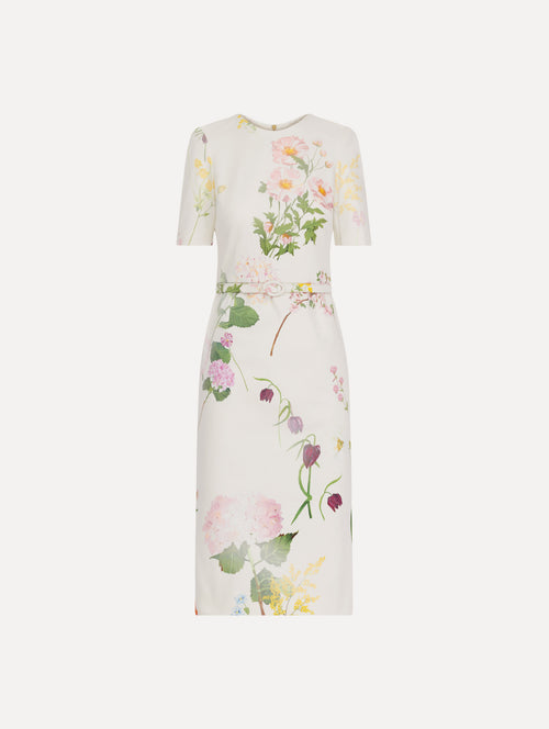The model is wearing the faded mixed botanical denim dress with midi sleeves and a washed floral print in white multi.