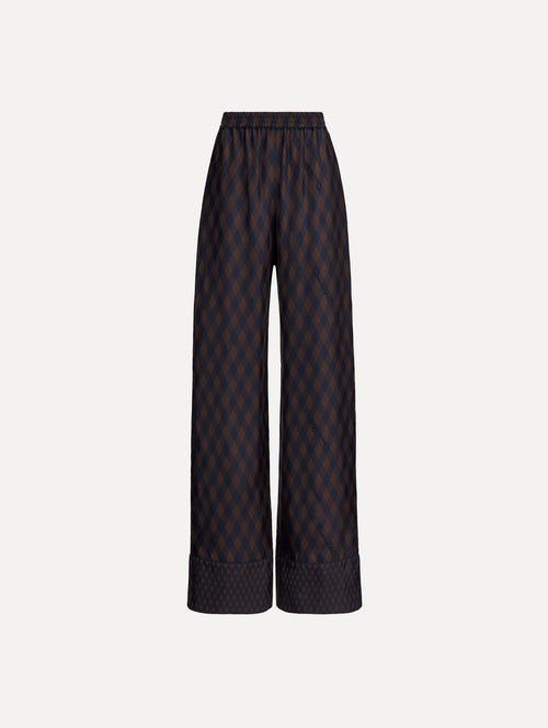 The model is wearing the Argyle Silk Twill Wide Leg Pant in navy and brown. 