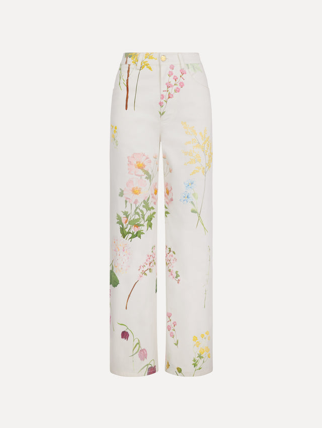 The model is wearing the faded mixed botanical denim pant with a washed floral print in cotton denim.