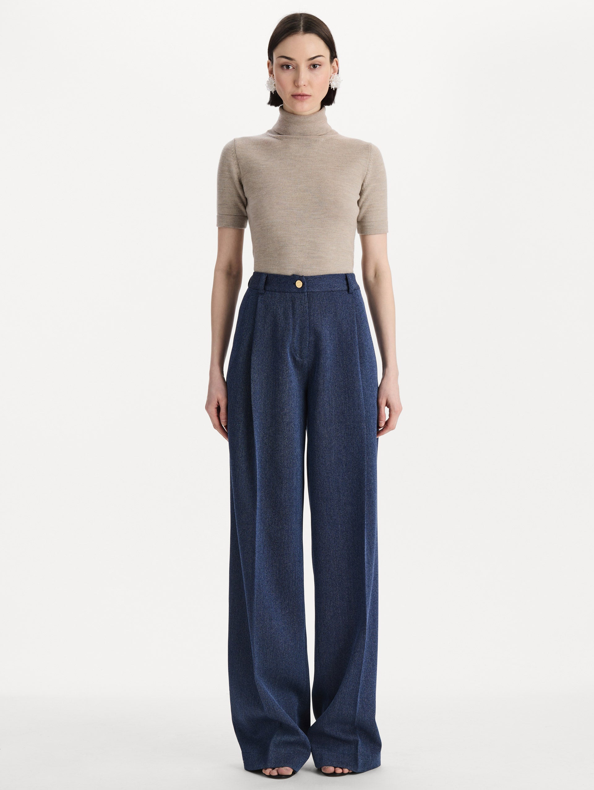 Model wearing indigo wool drill trousers with a straight-leg silhouette. Front view. 
