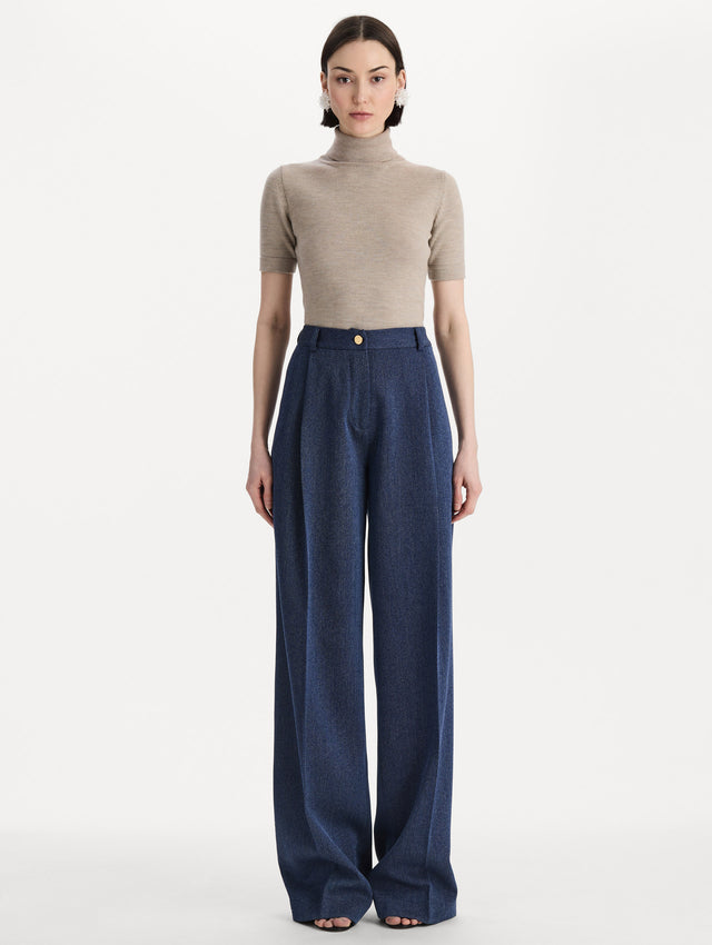 Model wearing indigo wool drill trousers with a straight-leg silhouette. Front view. 