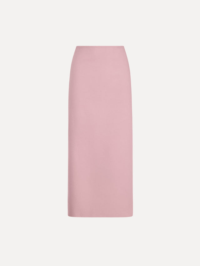The model is wearing the wool pencil skirt with a structured silhouette in the color blush.