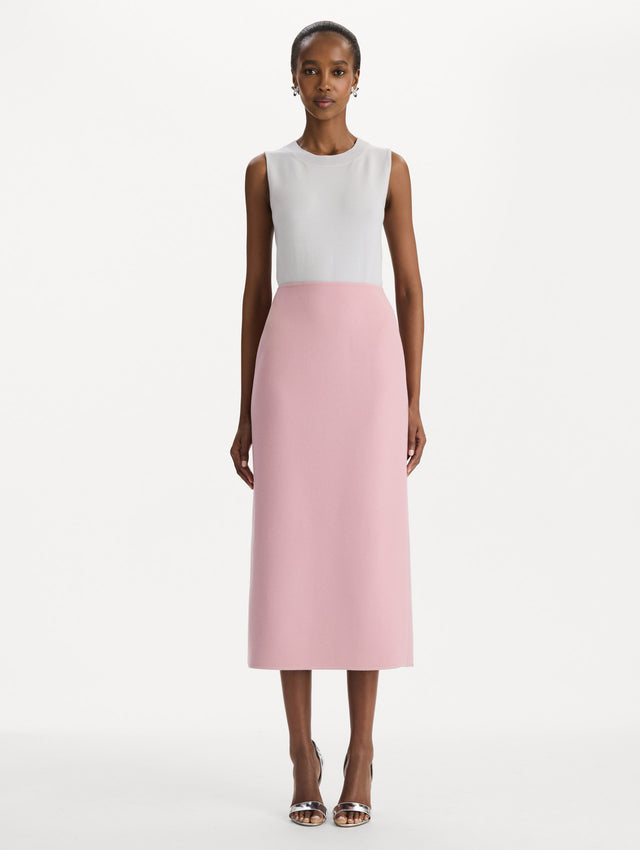 The model is wearing the wool pencil skirt with a structured silhouette in the color blush. Front view. 