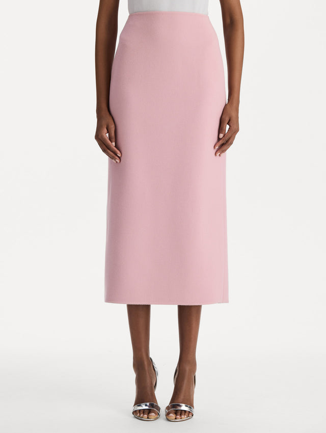 The model is wearing the wool pencil skirt with a structured silhouette in the color blush. Front view. 