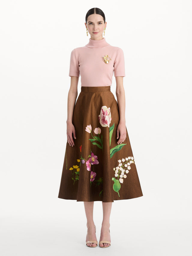 The model is wearing the mixed botanical midi skirt with an all-over floral print in stretch cotton. Front view.