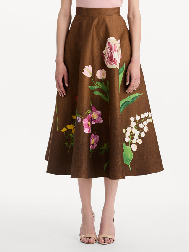 The model is wearing the mixed botanical midi skirt with an all-over floral print in stretch cotton. Front view.