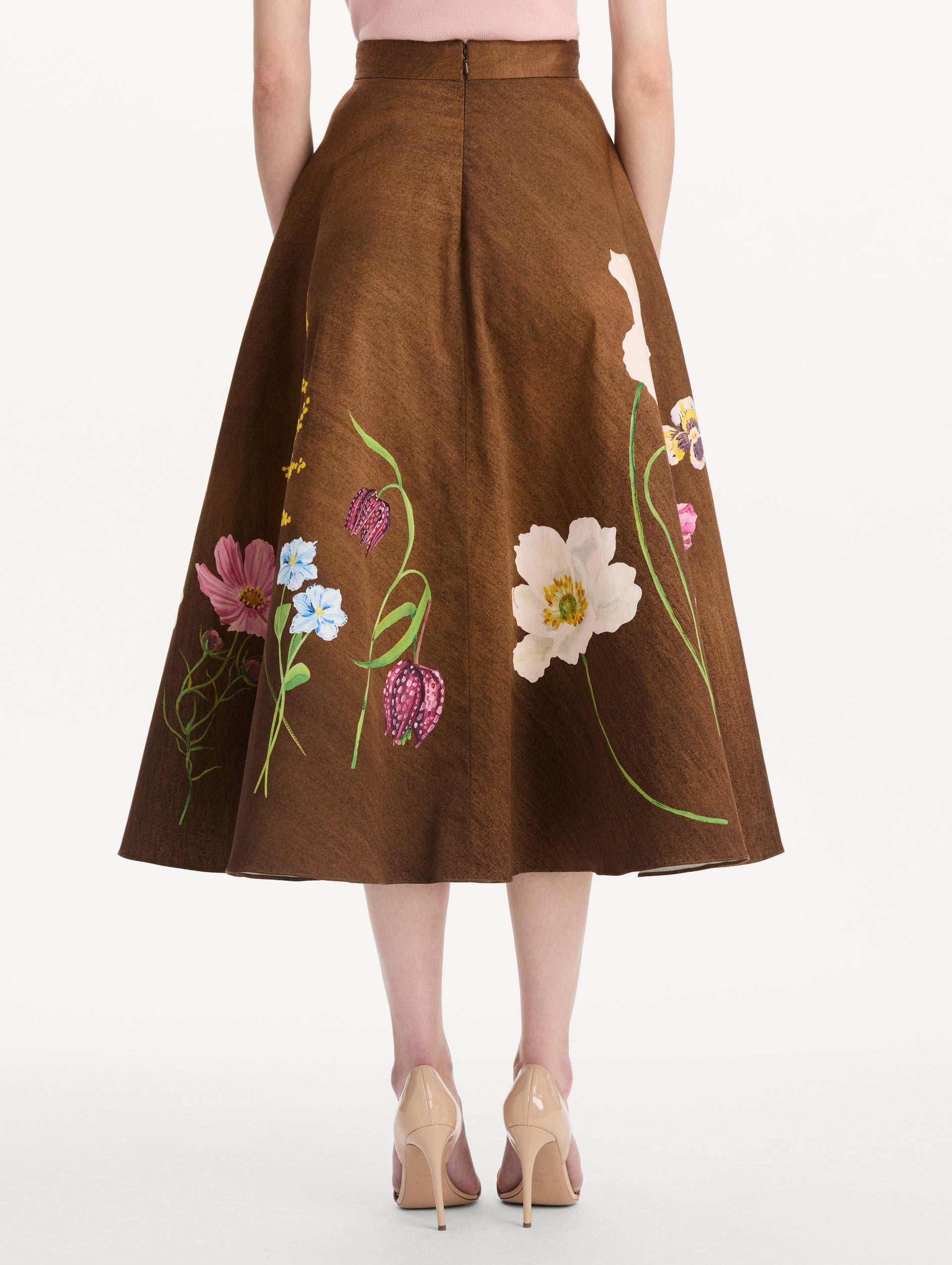 The model is wearing the mixed botanical midi skirt with an all-over floral print in stretch cotton. Back view.