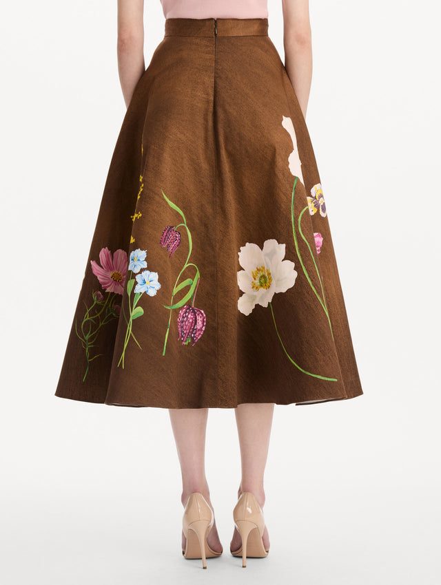 The model is wearing the mixed botanical midi skirt with an all-over floral print in stretch cotton. Back view.