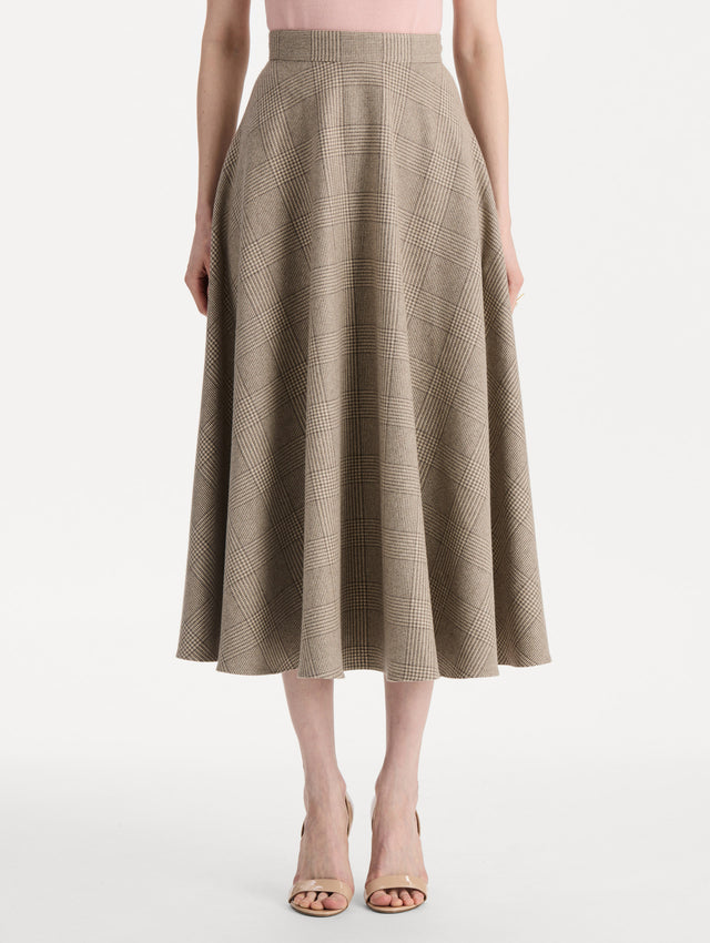 The model is wearing the plaid cashmere-blend skirt with a glen plaid pattern. Front view. 