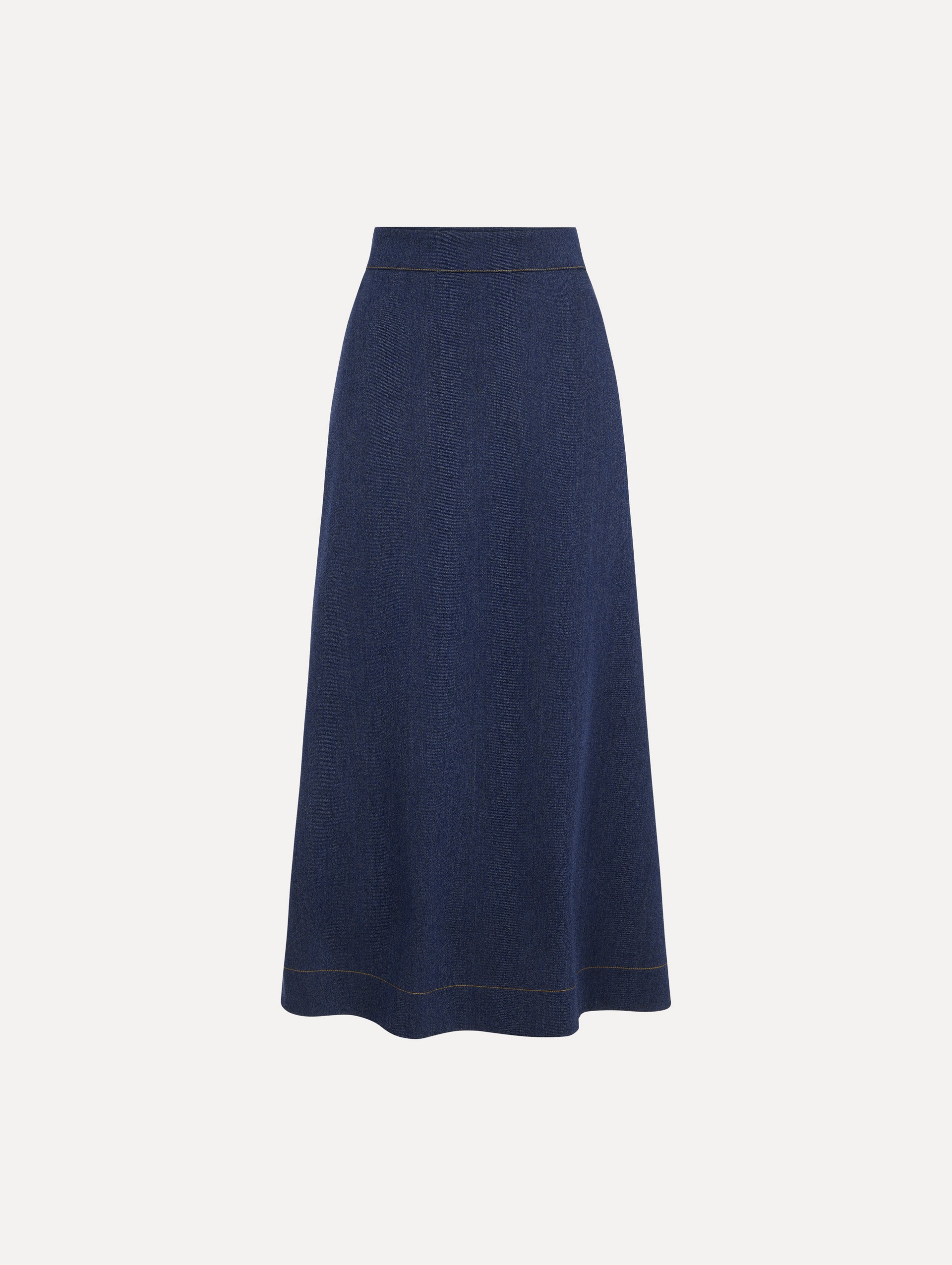The model is wearing the wool midi skirt in indigo wool with a tailored silhouette. 