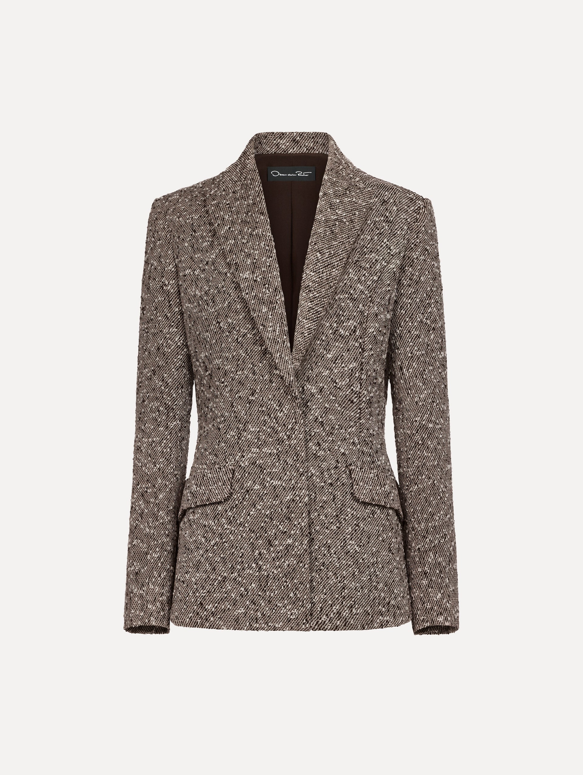 The model is wearing the slub wool tweed collared jacket with long sleeves in an ivory and brown palette.