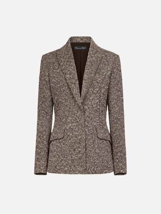 The model is wearing the slub wool tweed collared jacket with long sleeves in an ivory and brown palette.
