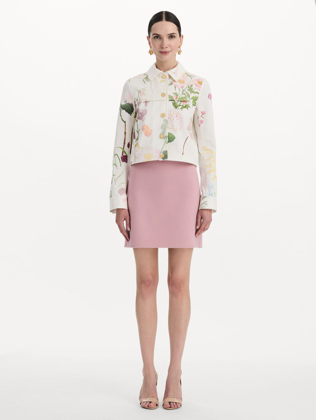 The model is wearing the faded mixed botanical denim jacket in the color white multi. Front view.