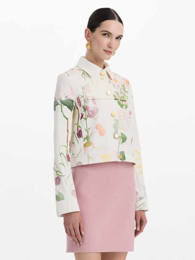 The model is wearing the faded mixed botanical denim jacket in the color white multi. Side view.