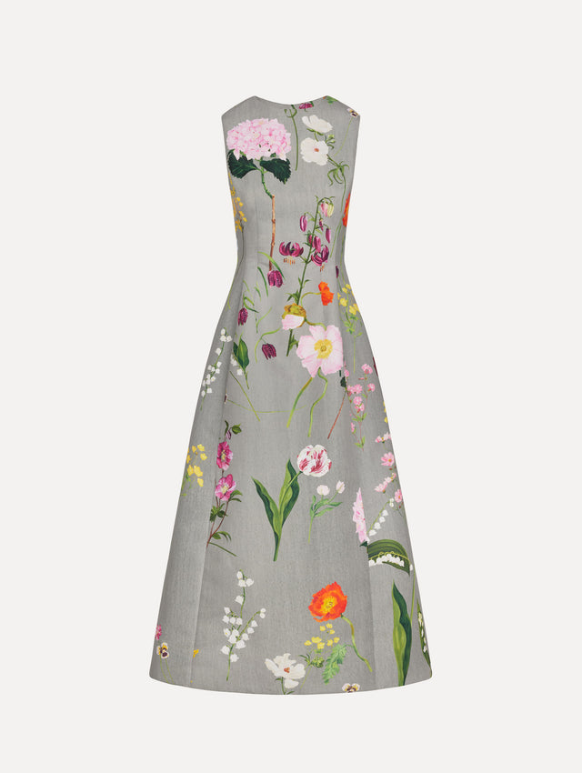 The model is wearing the mixed botanical faille cocktail dress with a sleeveless silhouette in the color grey multi. 