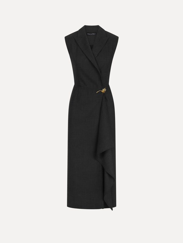 The model is wearing a charcoal wool dress with a draped wrap front and short sleeves.