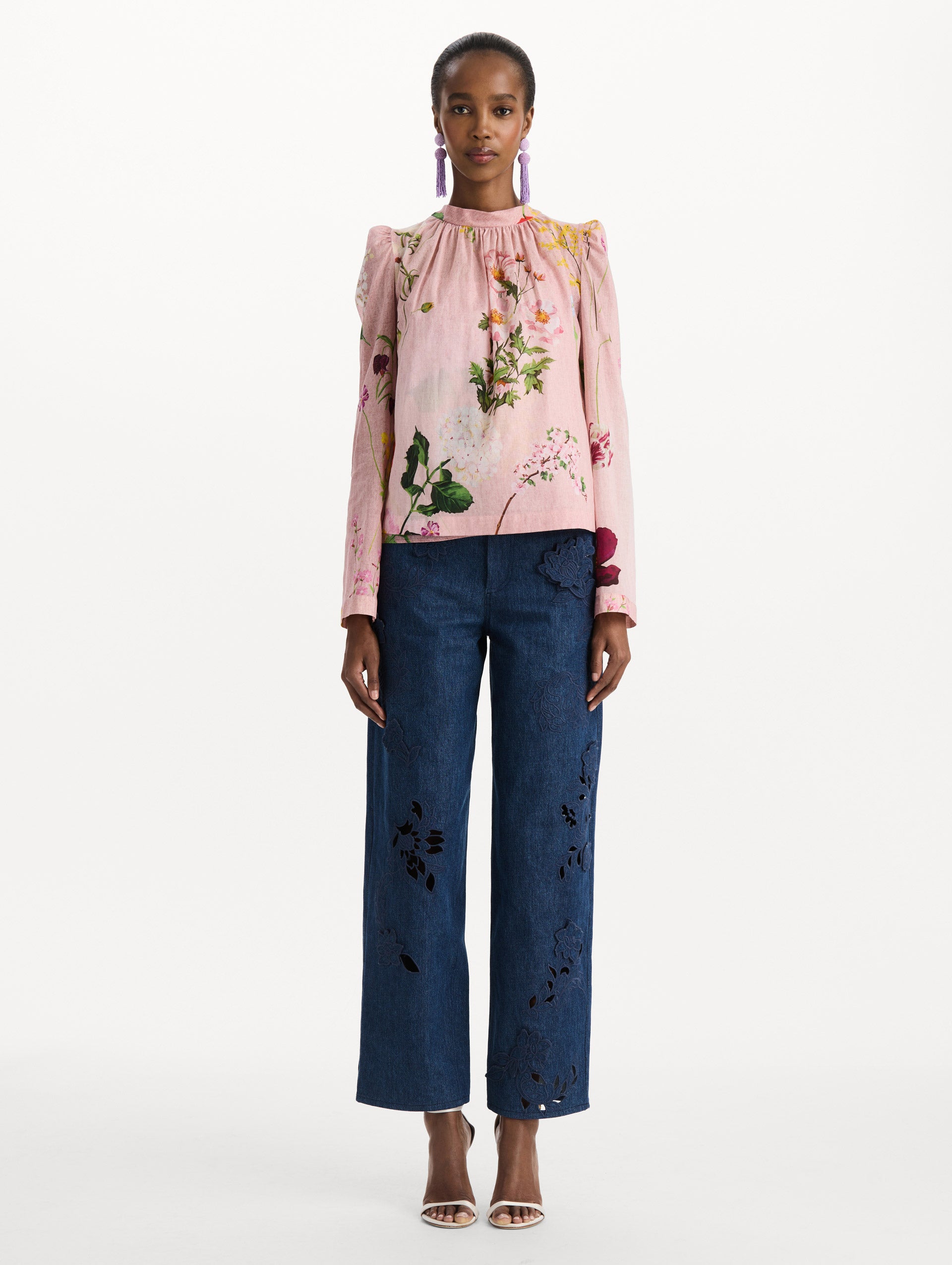 The model is wearing the mixed botanical tie-detailed blouse with a tie neckline and an all-over floral print in a blush multi palette. Front view. 