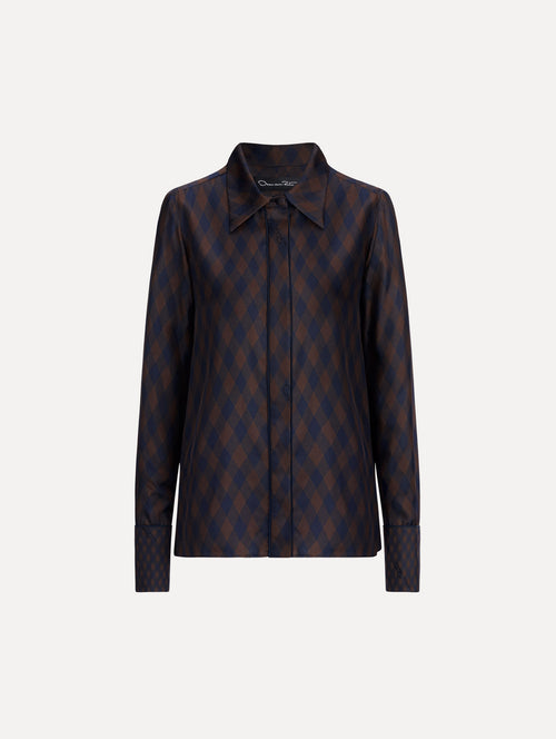 The model is wearing the Argyle Tie-Neck Silk Twill Blouse with long sleeves in navy and brown. 