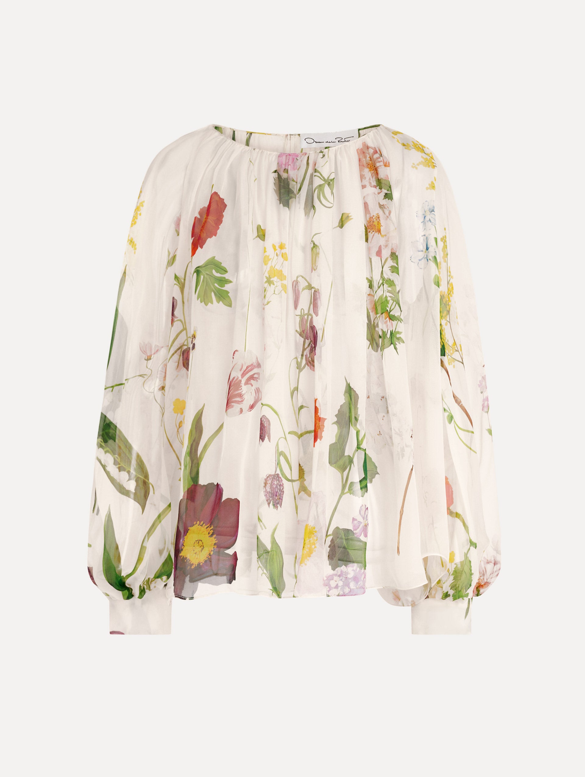 The model is wearing the mixed botanical silk chiffon blouse with long sleeves and an all-over floral print in ecru tones. 
