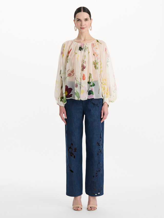 The model is wearing the mixed botanical silk chiffon blouse with long sleeves and an all-over floral print in ecru tones. Front view.