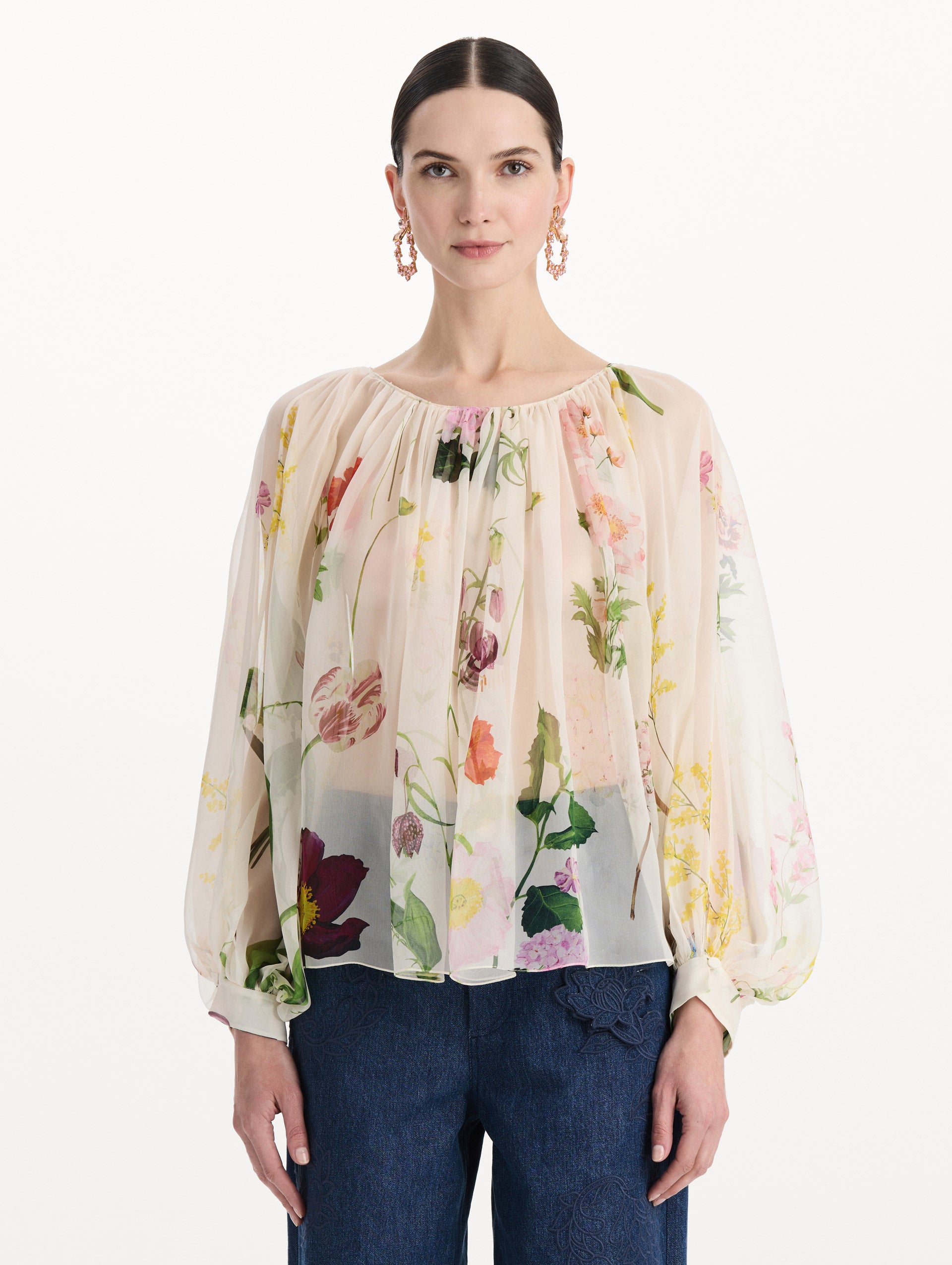 The model is wearing the mixed botanical silk chiffon blouse with long sleeves and an all-over floral print in ecru tones. Front view. 