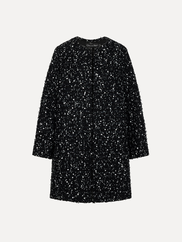 The model is wearing the sequin ribbon tweed coat with a black and white tweed finish and a tailored silhouette.
