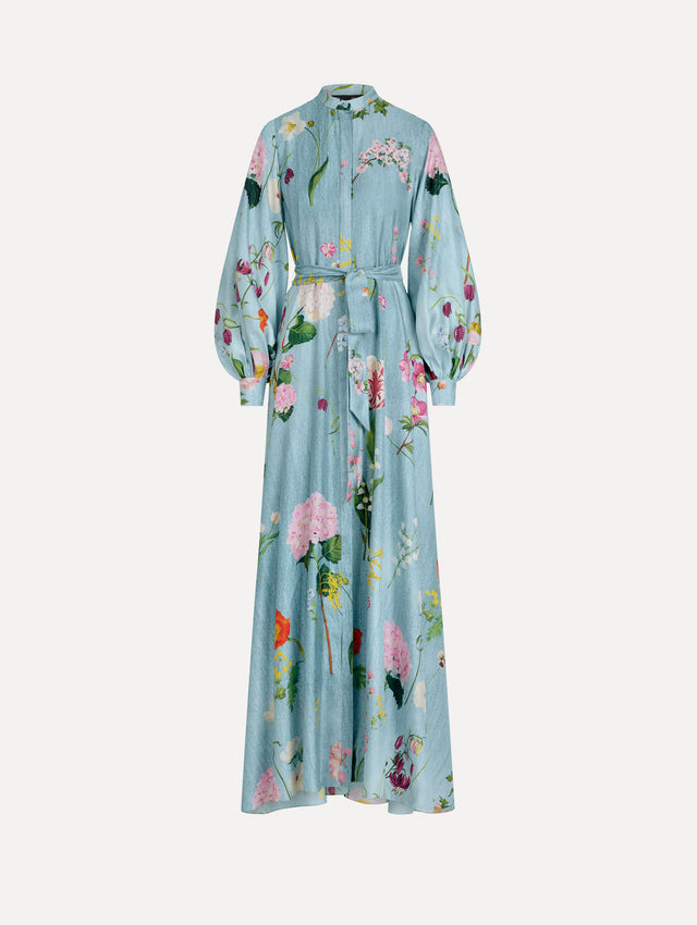 The model is wearing the mixed botanical silk twill caftan with long sleeves in blue multi. 