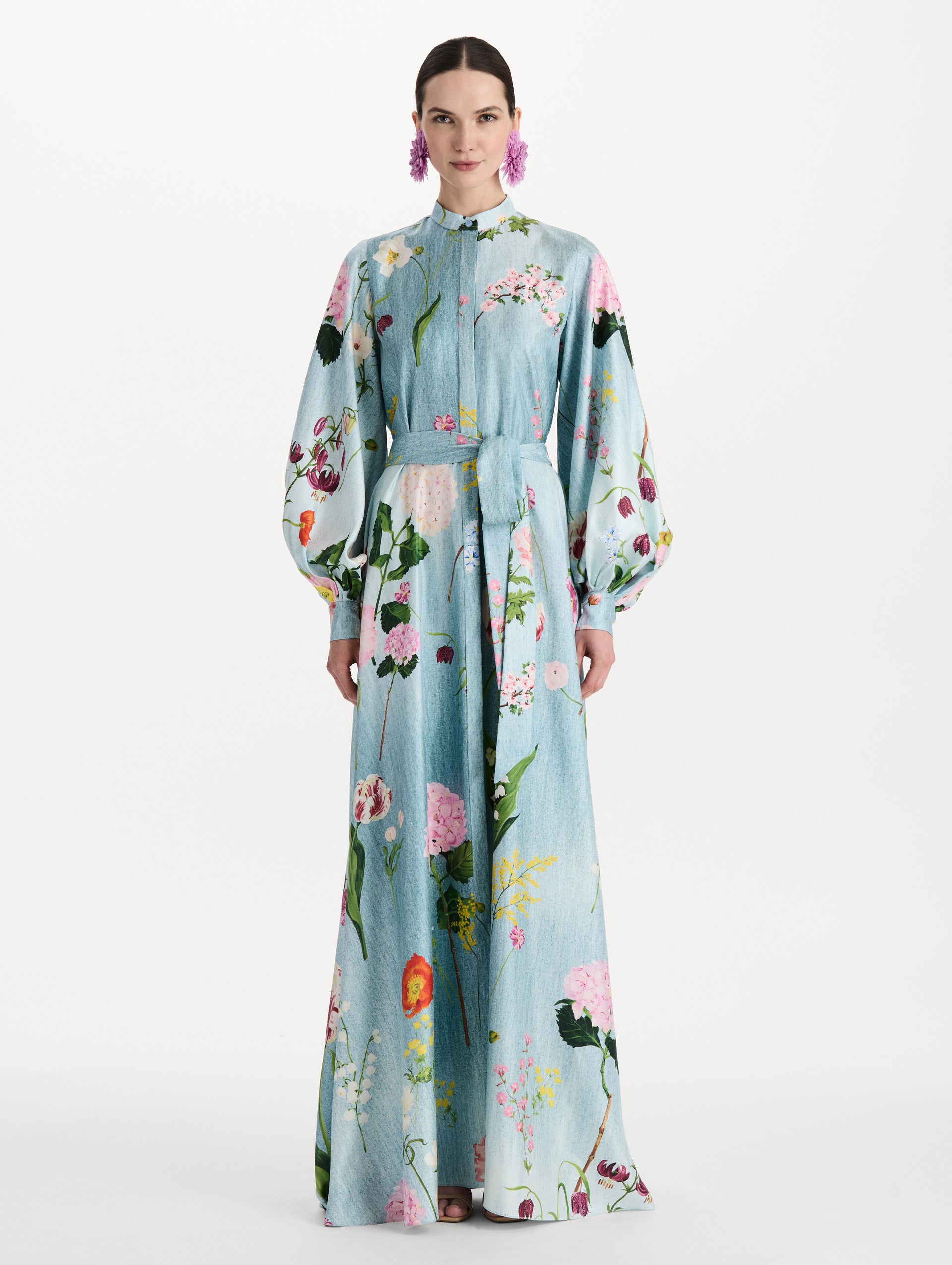 The model is wearing the mixed botanical silk twill caftan with long sleeves in blue multi. Front view. 