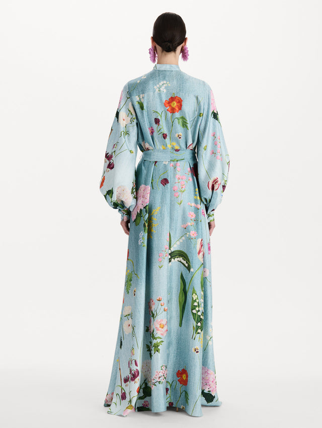 The model is wearing the mixed botanical silk twill caftan with long sleeves in blue multi. Back view. 