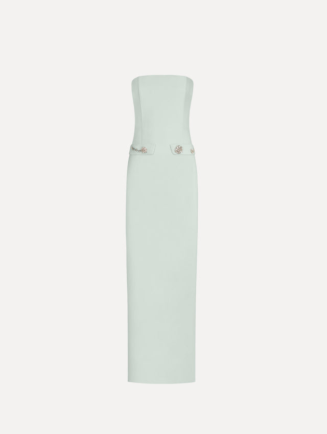The Crystal Floral Embroidered Gown in Saltwater Blue. Featuring a strapless neckline, faux front flap pockets with crystal embroidery, and a long, column silhouette. Front View.