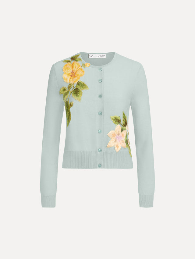 The Chiné Dominican Mixed-Floral Threadwork Cardigan in Saltwater Blue with threaded Dominican florals. Featuring buttons closures down the center, long sleeves, crew neckline, and ribbed trims. Front View.