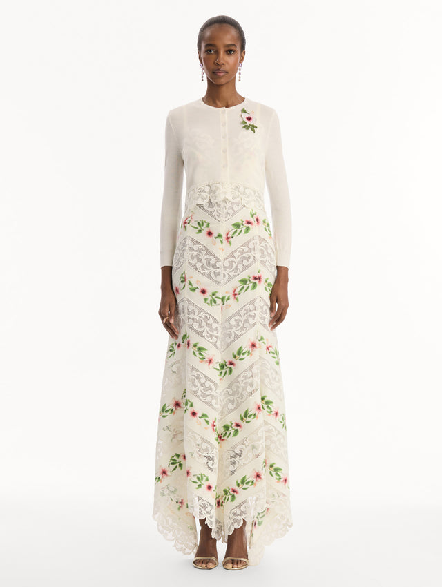 The model is wearing the Chiné Hibiscus Threadwork Cropped Cardigan in Ivory. Featuring a threaded Chiné hibiscus and intricate guipure lace trim. Front View.