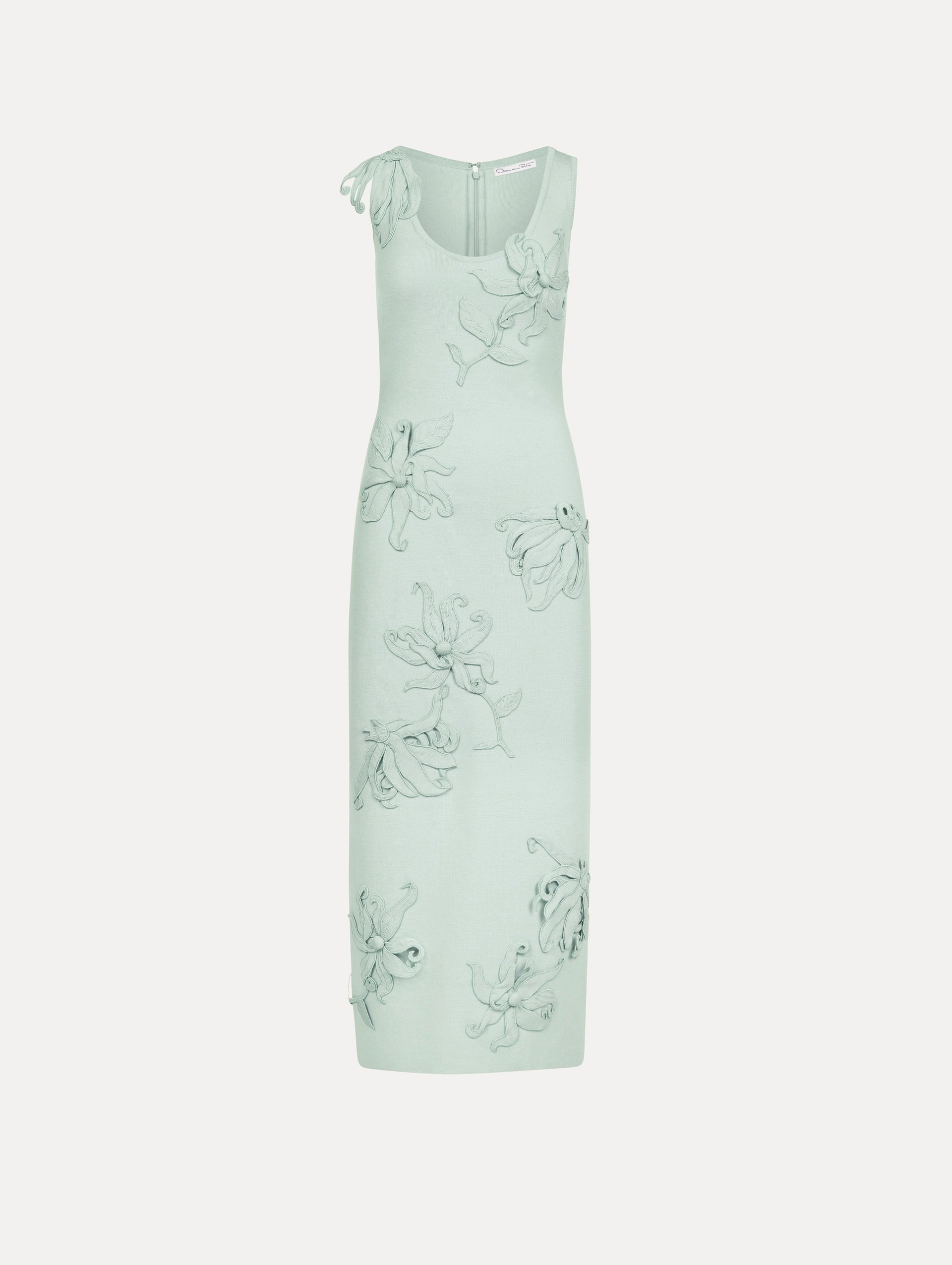 The model is wearing the Hibiscus Embroidered Knit Pencil Dress in Saltwater Blue. Featuring a structural hibiscus embroidery, a scoop neckline, and midi length. Front View.