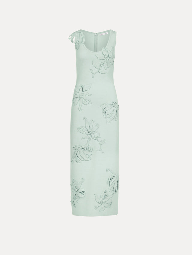 The model is wearing the Hibiscus Embroidered Knit Pencil Dress in Saltwater Blue. Featuring a structural hibiscus embroidery, a scoop neckline, and midi length. Front View.