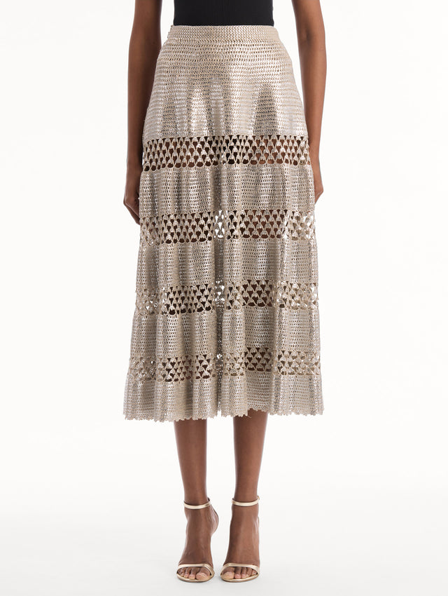 The model is wearing the Silver Foil Midi Skirt. Featuring a tiered silhouette with striped intricate openwork and midi length. Front View.