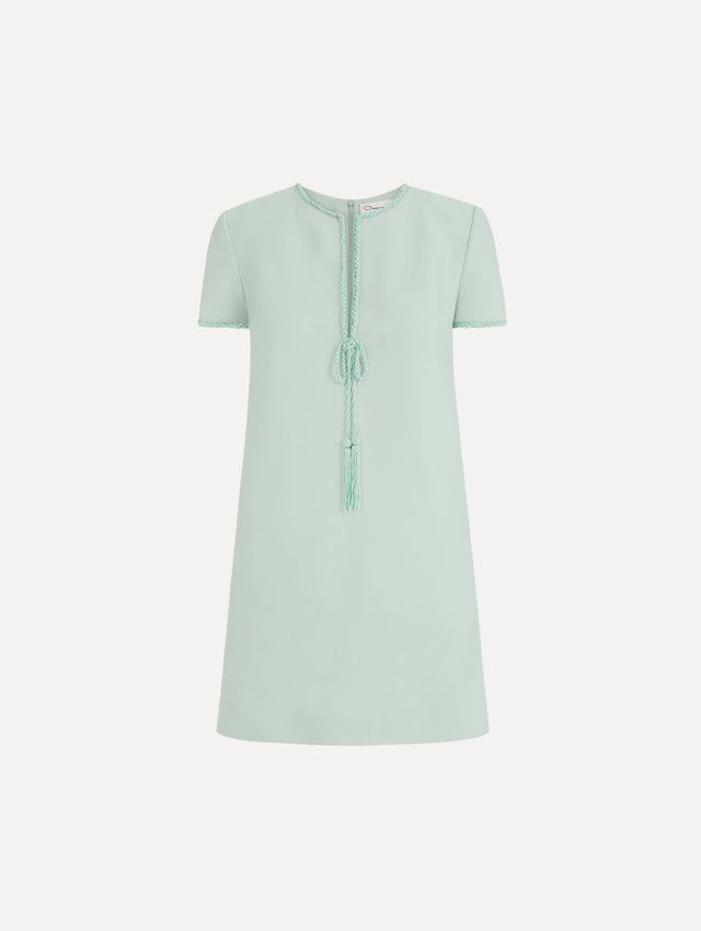 The Beaded Bow-Detail Shift Dress in Saltwater Blue. Featuring a beaded bow detail at the neckline with tassel ties and subtle trim along the edges. Front View.