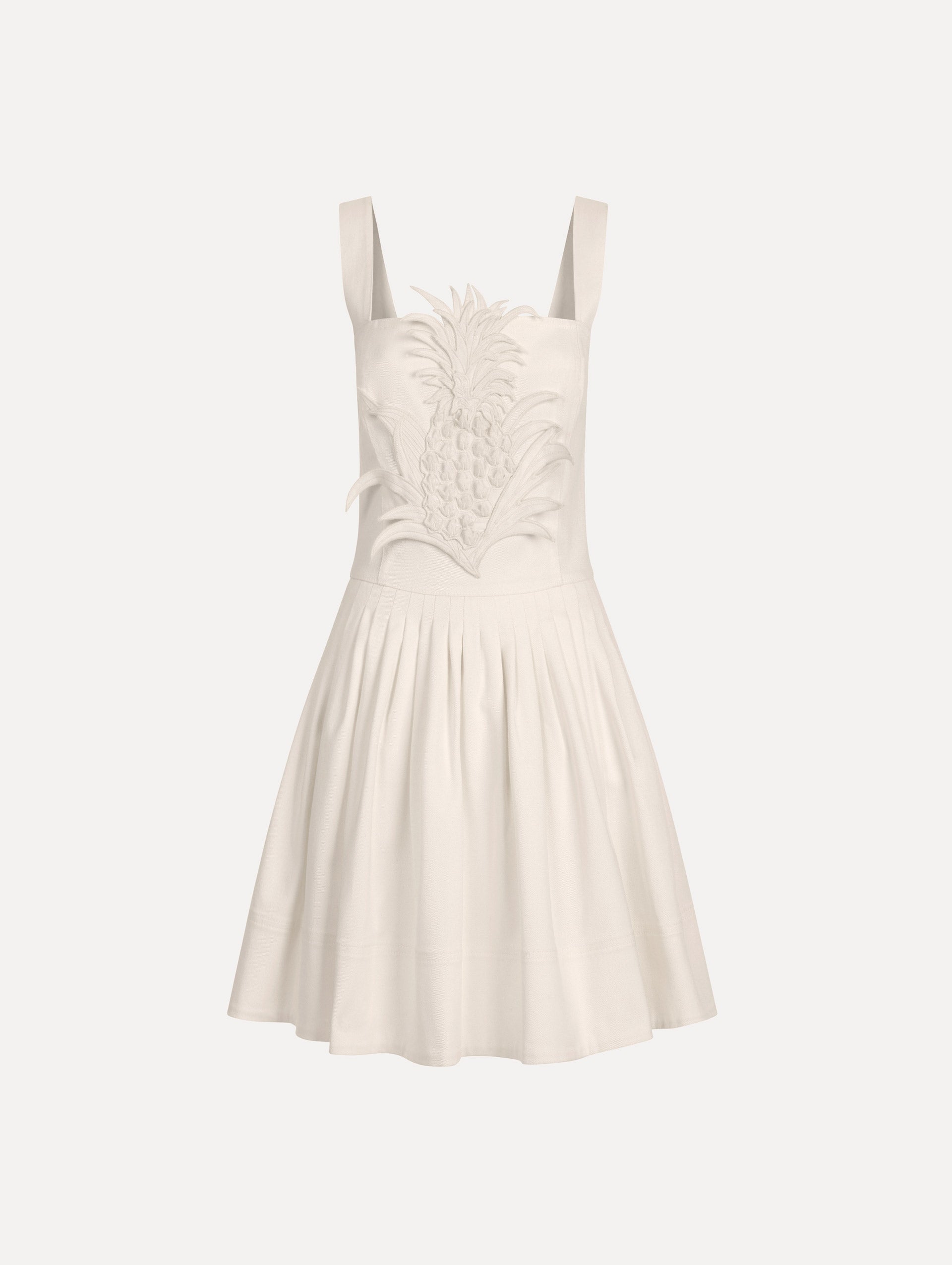The model is wearing the pineapple appliqué denim dress with a structured bodice in the color white. 