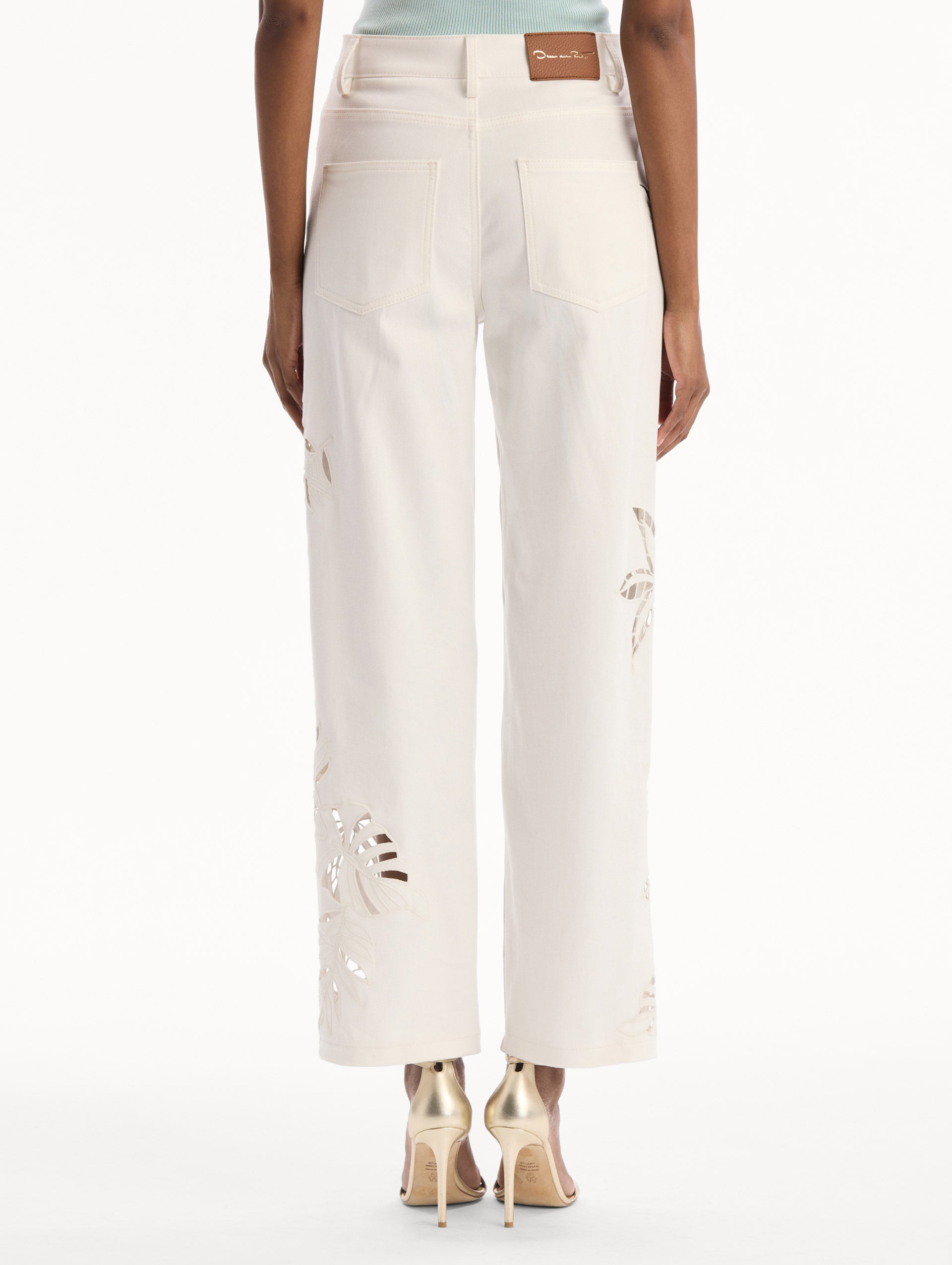 Palm Leaves Cutout Denim Pant in White. back view.