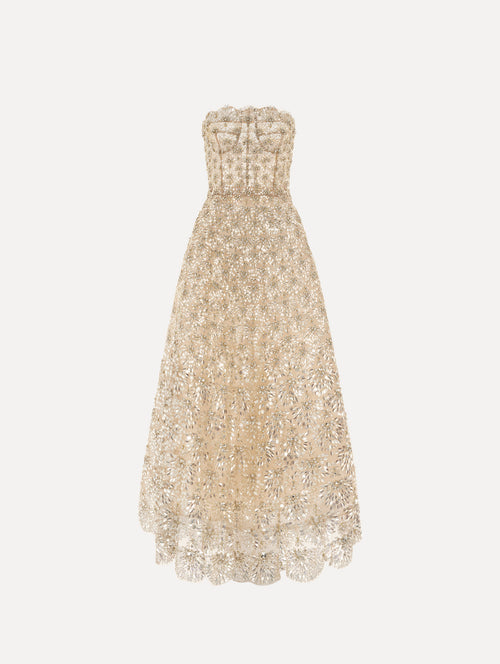 The model is wearing the crystal & glass embroidered gown with a strapless fit-and-flare silhouette in the color lemonade.