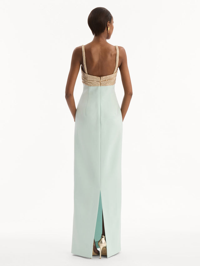 The model is wearing the Twist-Detail Metallic Column Gown in Saltwater Blue. Featuring a metallic twist-detail bodice and long, column silhouette. Back View.