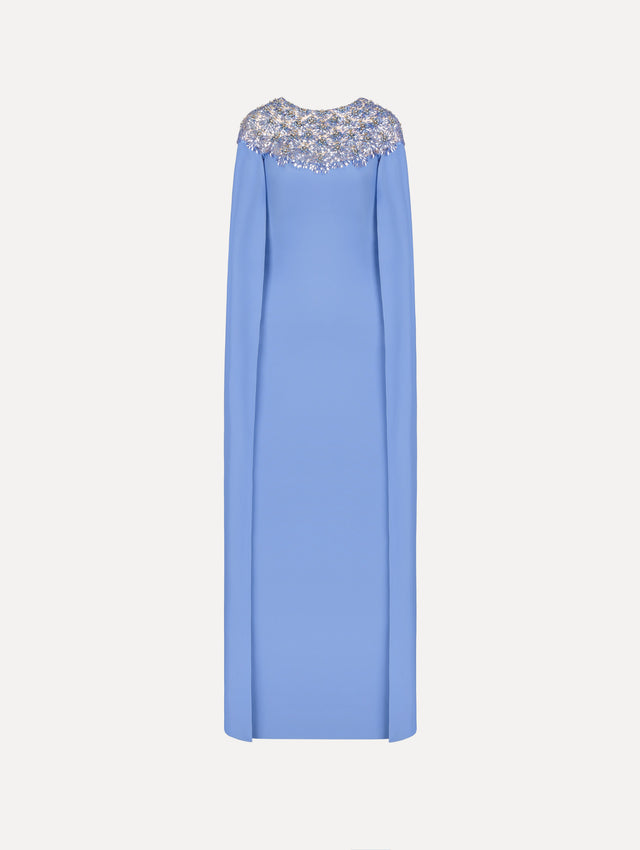 The Crystal & Glass Embroidered Caftan in a hydrangea blue color. Featuring crystal and glass bead embroidery at the collar, flowing cape-like sleeves, and a long skirt. Front View.