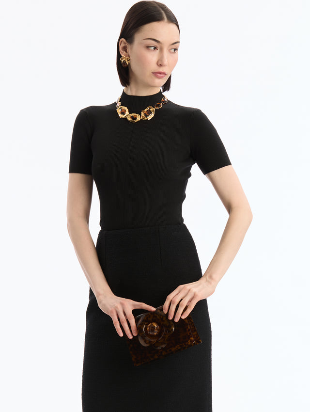 Tortoise Plexiglass Mini TRO Bag (Clutch). Rectangular with central flower detail. Front View.