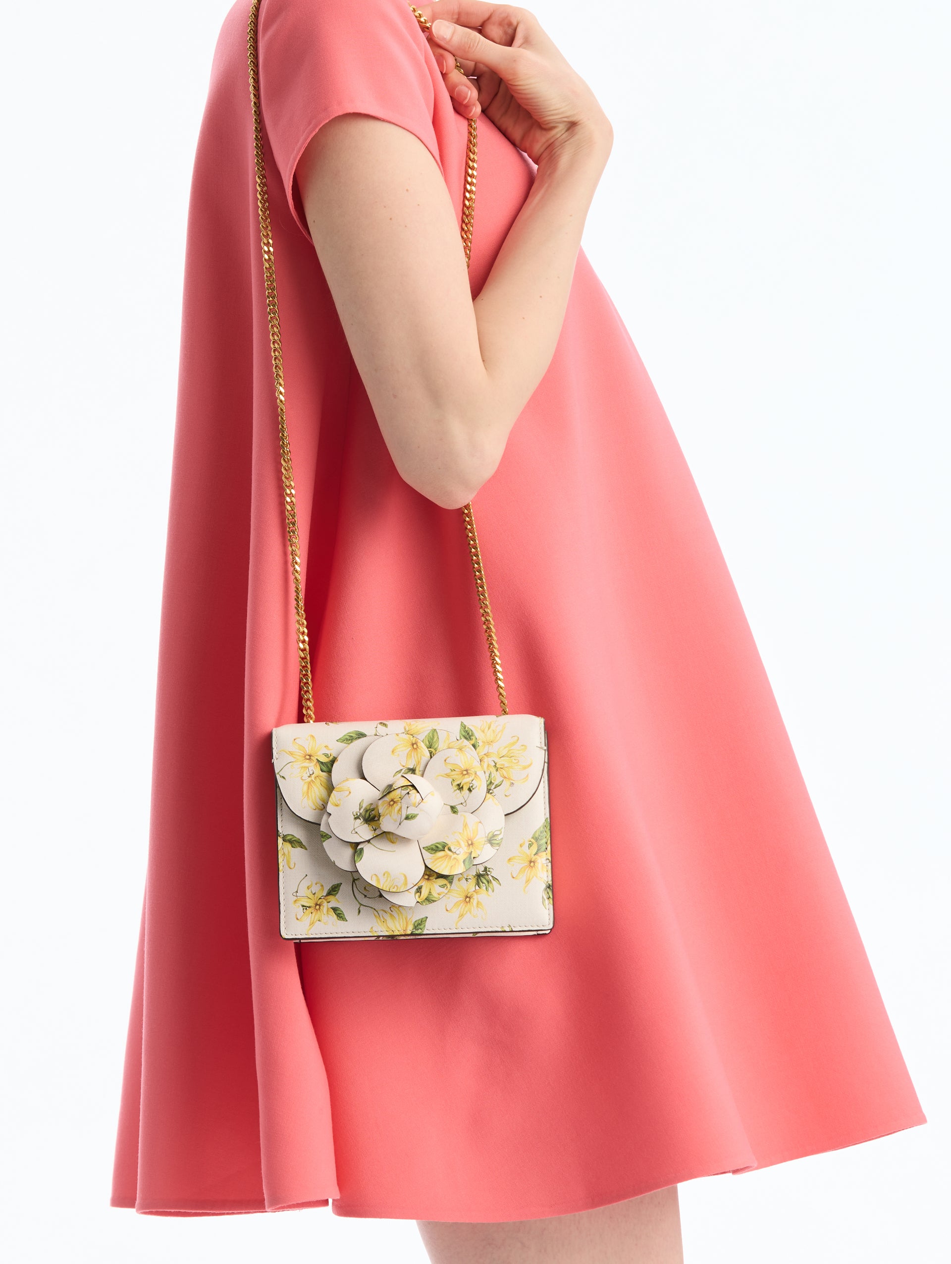 Mini Leather Shoulder bag in Ylang Ylang Print. Rectangular with Flower Closure on Side. Front View.