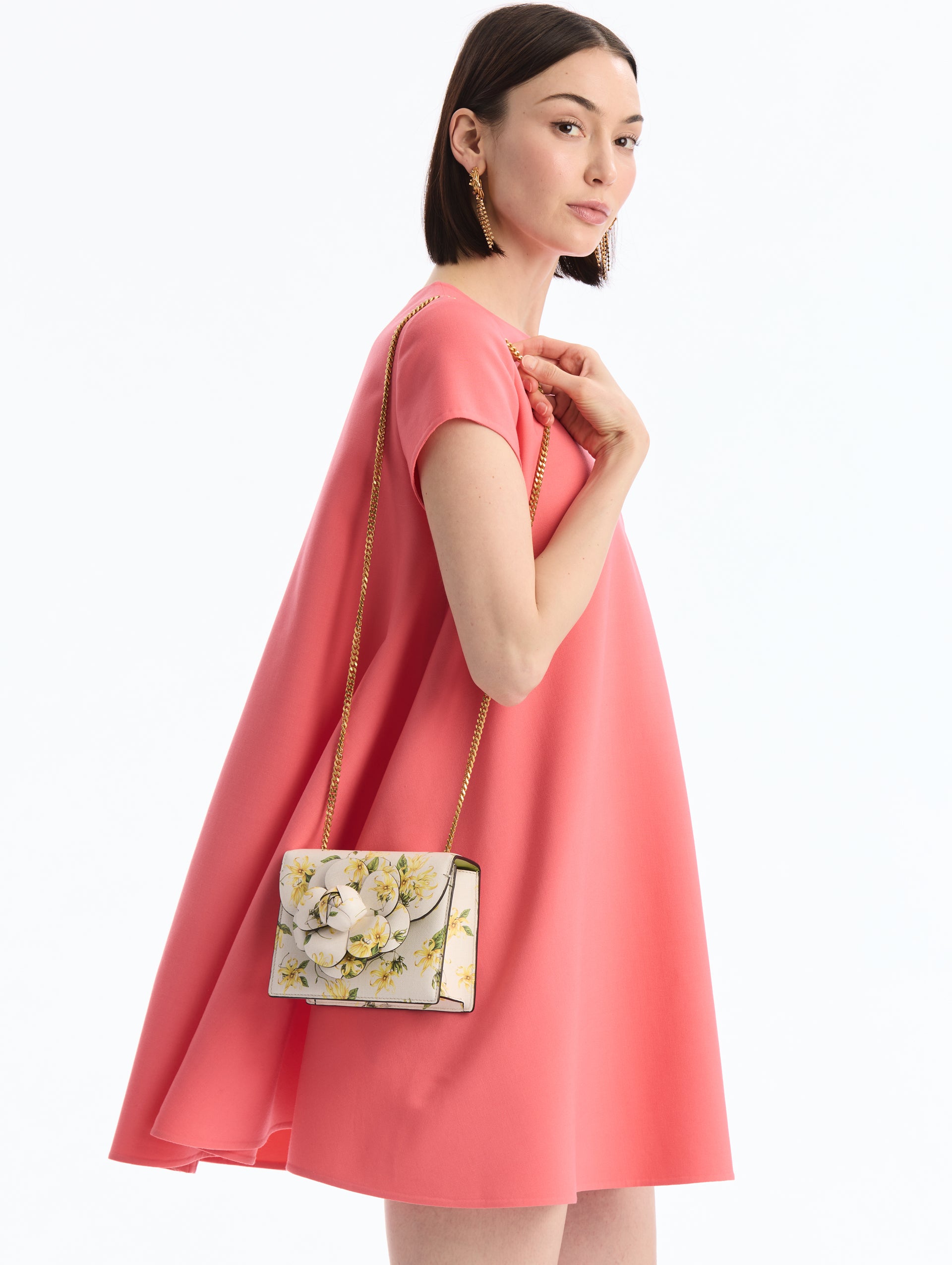 Mini Leather Shoulder bag in Ylang Ylang Print. Rectangular with Flower Closure on Side. Side View.