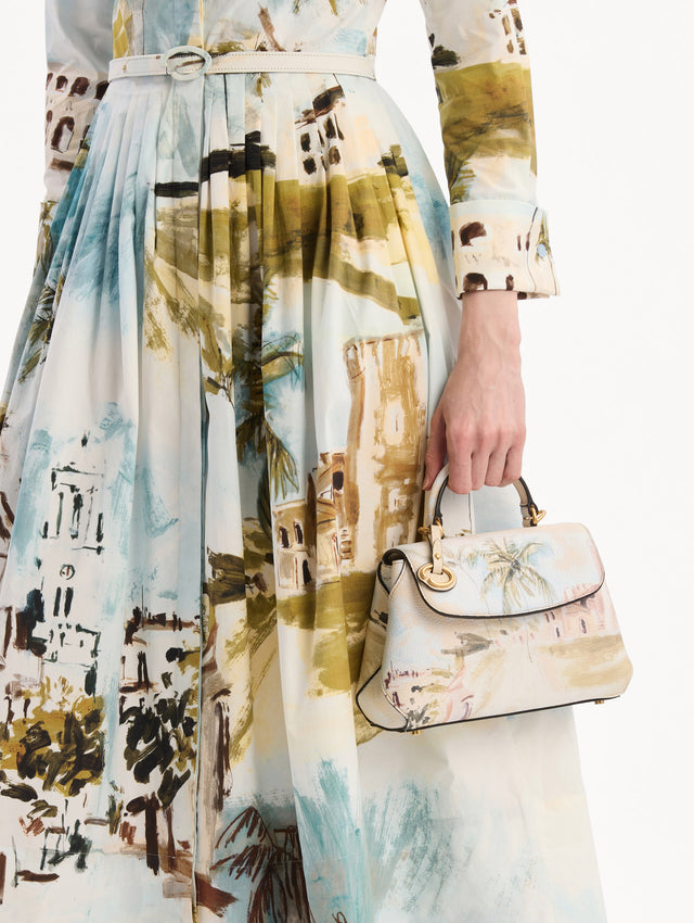 The model is wearing The Mini Poppy adorned with the Dominican Landscape print. Detail View.