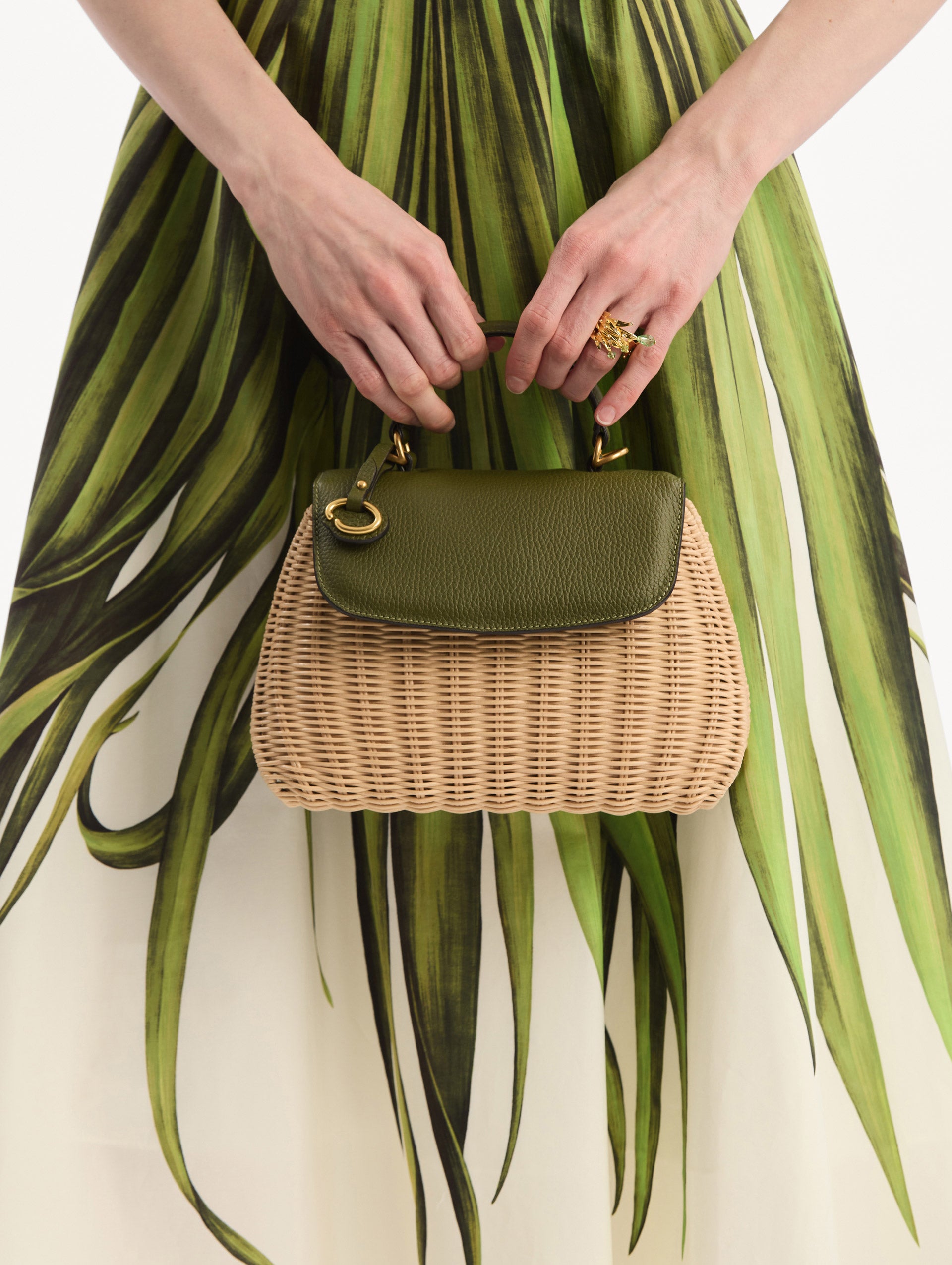 The model is wearing The Mini Poppy in Wicker in Olive. Front View.