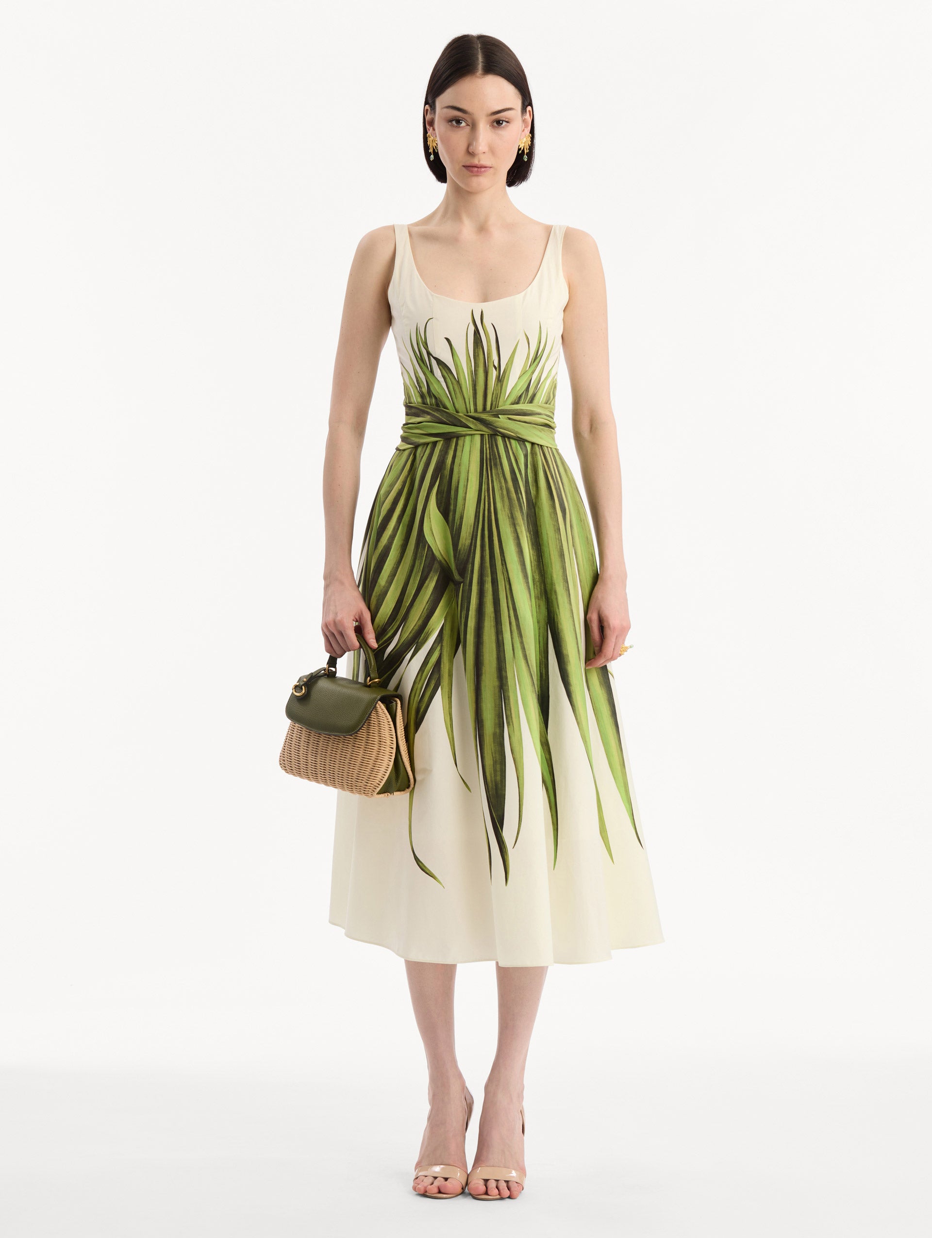 The model is wearing The Mini Poppy in Wicker in Olive. Detail View.
