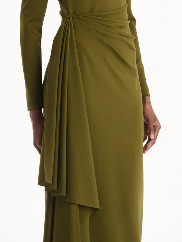 The model is wearing the Drape-Detail Jersey Gown in olive green. Featuring long sleeves, a body-skimming silhouette, gathered detail at waist, and long skirt. Detail View.